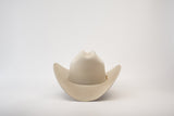 The 5X Dorado Belly is a light beige cowboy hat, made from fur felt, featuring a wide brim and slightly curved crown, presented on a plain white background.