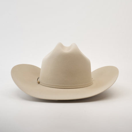 The 500X Superior Belly is a premium Western cowboy hat in light tan, crafted from 100% belly beaver fur. It features a wide brim and a teardrop-shaped crown, set against a plain white background.