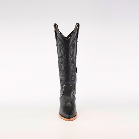 The Linda Studs Tall Shaft Black boot from the Platinum Collection is presented on a neutral background, showcasing intricate decorative stitching, a pointed J toe, and a wooden sole with elegant swirling patterns.