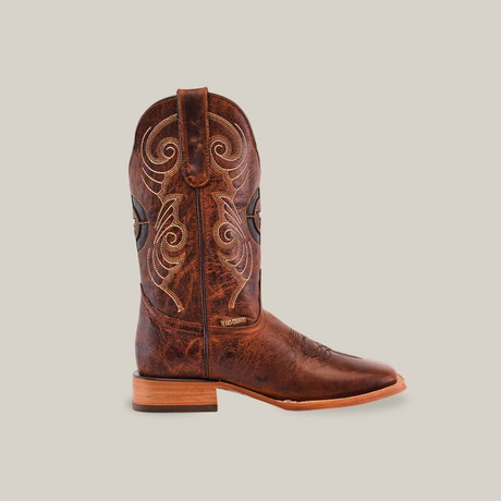 The Fresno Shedron Star - Square Toe cowboy boot features a textured and slightly worn premium cowhide leather with intricate swirl stitching on the shaft, a flat wooden heel, and a square toe, creating a classic Western look against a plain background.