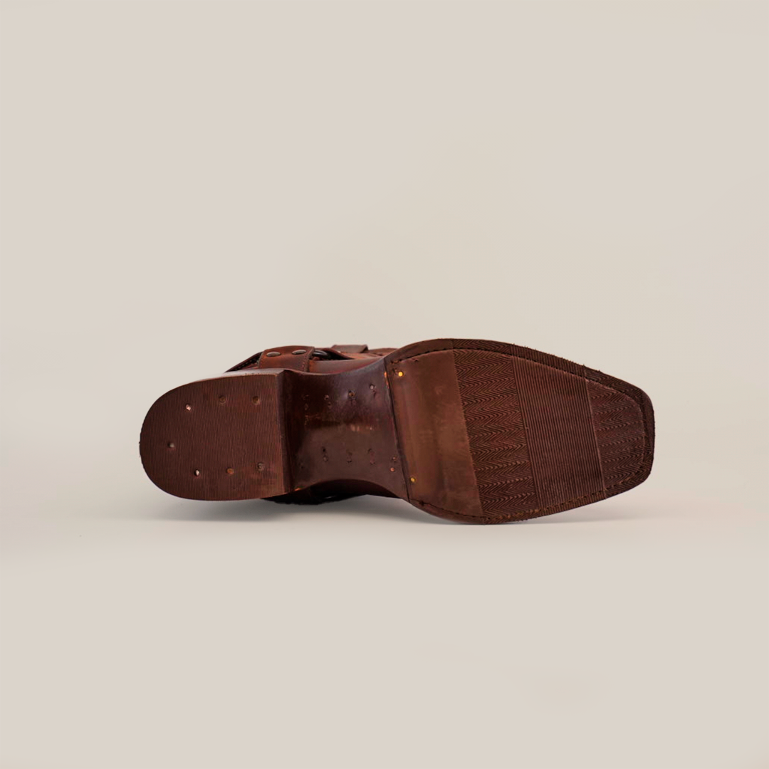 The image displays the sole of an Azkar Moka brown leather shoe with a slip-resistant pattern near the toe and evenly spaced small nails, elegantly positioned on a plain white background.