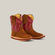 A pair of Sommer Camel Red Shaft small baby cowboy boots features a square toe, brown suede, and red and pink stitching on the upper part, set against a plain light gray background.