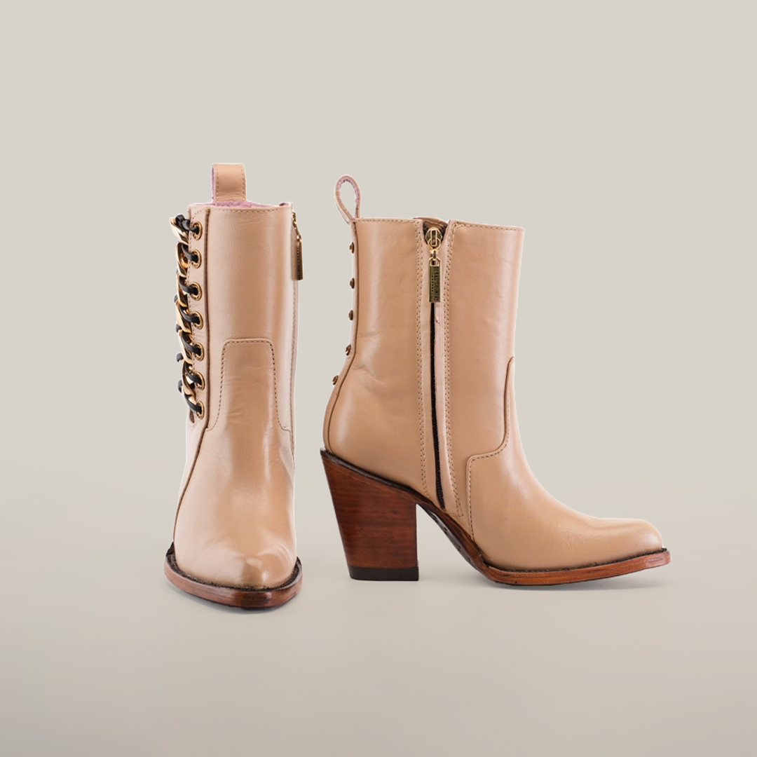 Introducing the Francia Rings Bootie Cream - J Toe from our Platinum Collection: Light brown premium leather ankle boots with block heels. The left boot has a side zipper; the right one features decorative laces and metal eyelets, both with a handy pull loop at the back.