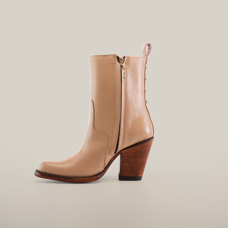 The Francia Rings Bootie Cream - J Toe from the Platinum Collection is a stunning single tan leather ankle boot with a side zipper and stylish wooden block heel, crafted from premium leather and elegantly displayed against a plain white background.