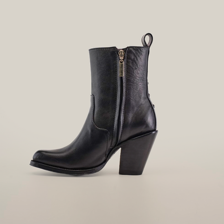 The Francia Rings Bootie Black - J Toe from the Platinum Collection exudes elegance with a decorative chain detail and zipper closure. Handcrafted by expert bootmakers, this black leather ankle boot is lined with rich dark purple, embodying luxury against a crisp white background.