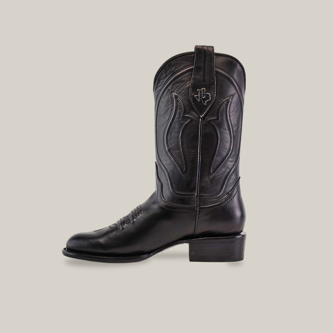 Introducing the Western - Platinum - Black cowboy boot, with elegant decorative stitching and a small emblem near the top. This Roper Toe boot features a low heel and is displayed on a white background, reflecting the refined style of our Platinum collection.