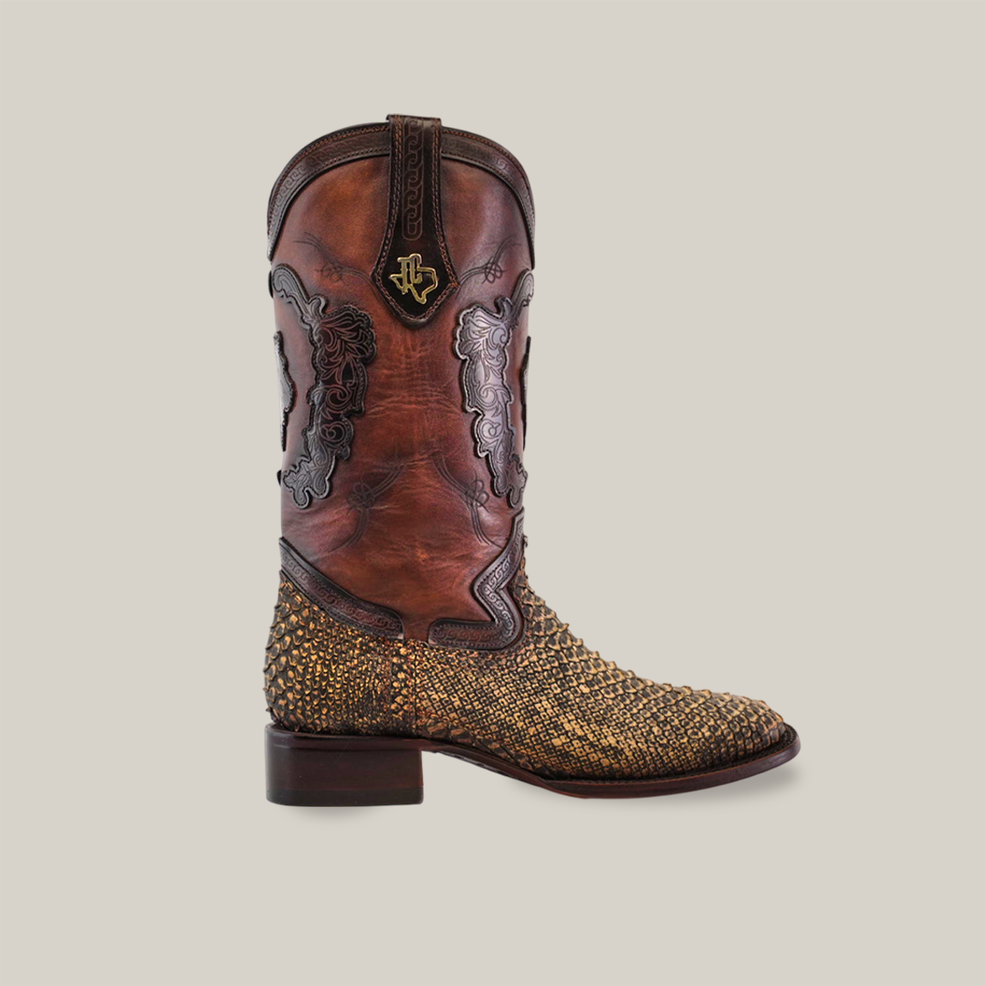 The Exotic Python - 4G - Vintage Honey - Square Toe boot features intricate brown leather detailing with a beaded lower design, a dark brown heel, a durable Goodyear welt sole, and a decorative emblem near the top. It stands out against the plain white background as an emblem of cowboy culture.