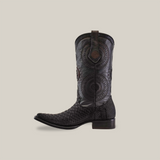 The Exotic Python - Platinum - Matte Black - Versy Toe cowboy boot features intricate circular patterns and scales like python leather. It has a medium heel, a pull tab, and is set against a plain white background.