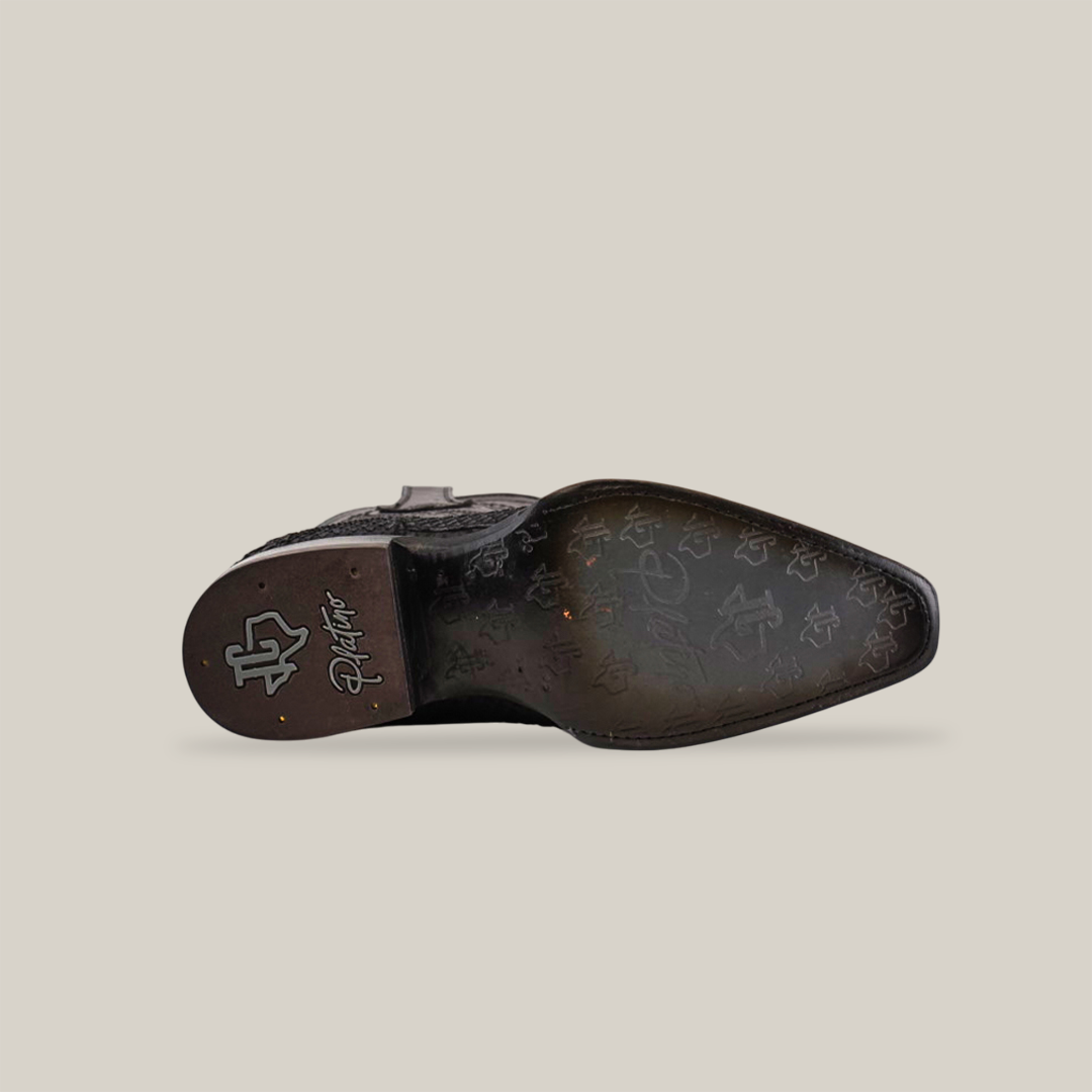 The image displays the sole of the Exotic Python - Platinum shoe in Matte Black with a Versy Toe, crafted from Python Leather. The sole features textured patterns like star shapes, and an unreadable logo on the heel. The shoe stands out against a plain white background.