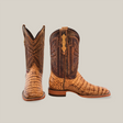 The Exotic Caiman Belly - Antique boots are two-tone with embossed leather detailing, featuring a light tan foot and darker brown shaft adorned with intricate patterns. Positioned against a plain background, they exude classic western elegance in a square toe design.