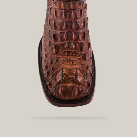 Close-up of the Exotic American Alligator Head boot in brown, showcasing a square toe design against a light gray background.