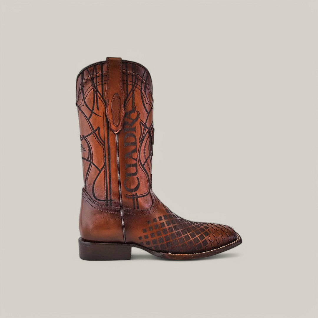 The Over Honey Laser & Embroidery & Woven - Square Toe - CU500 cowboy boot showcases intricate embroidery and decorative patterns on the shaft and toe, complemented by a square toe and low heel, all set against a plain light gray background.