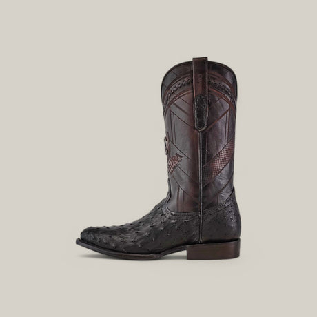 The Cuadra Black Ostrich Laser & Woven - Round Toe - CU554 cowboy boot showcases intricate stitching and embossing. It features a pointed toe, pull straps, and sits stylishly against a light grey background.