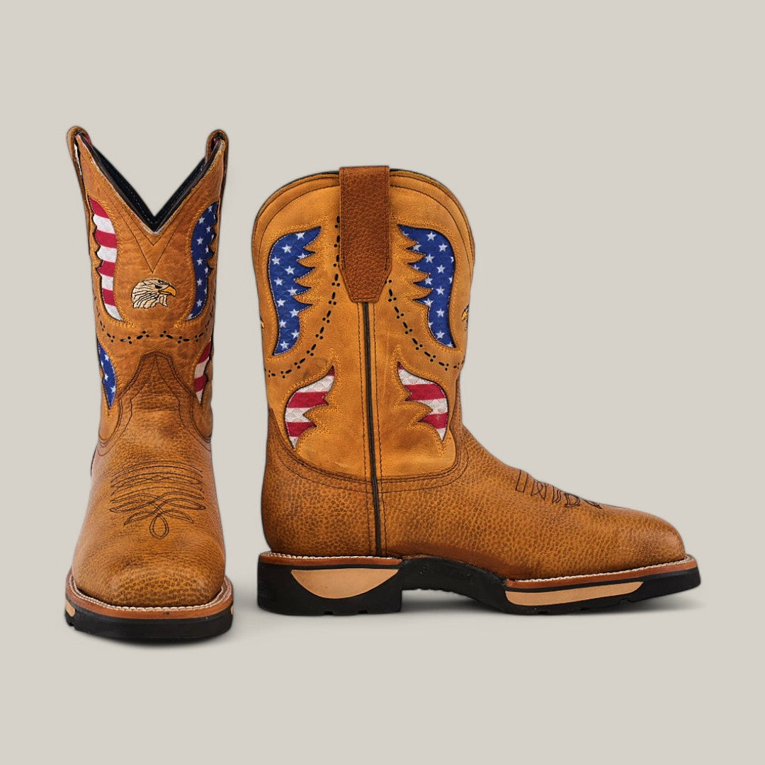 The Taurus Honey Composite Toe - E6189 boots feature a Texas Country style with American flag accents and eagle stitching. Their tall shafts boast star patterns in red, white, and blue on a tan background. The durable design with black soles is perfect for making a bold statement.