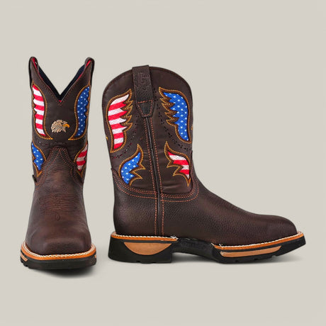 The Taurus Moka Soft Toe - E6189 is a distinctive pair of brown cowboy boots featuring American flag patterns on the shafts, wing and star designs in red, white, and blue with an eagle emblem. Tan-highlighted soles and stitching enhance its durability.