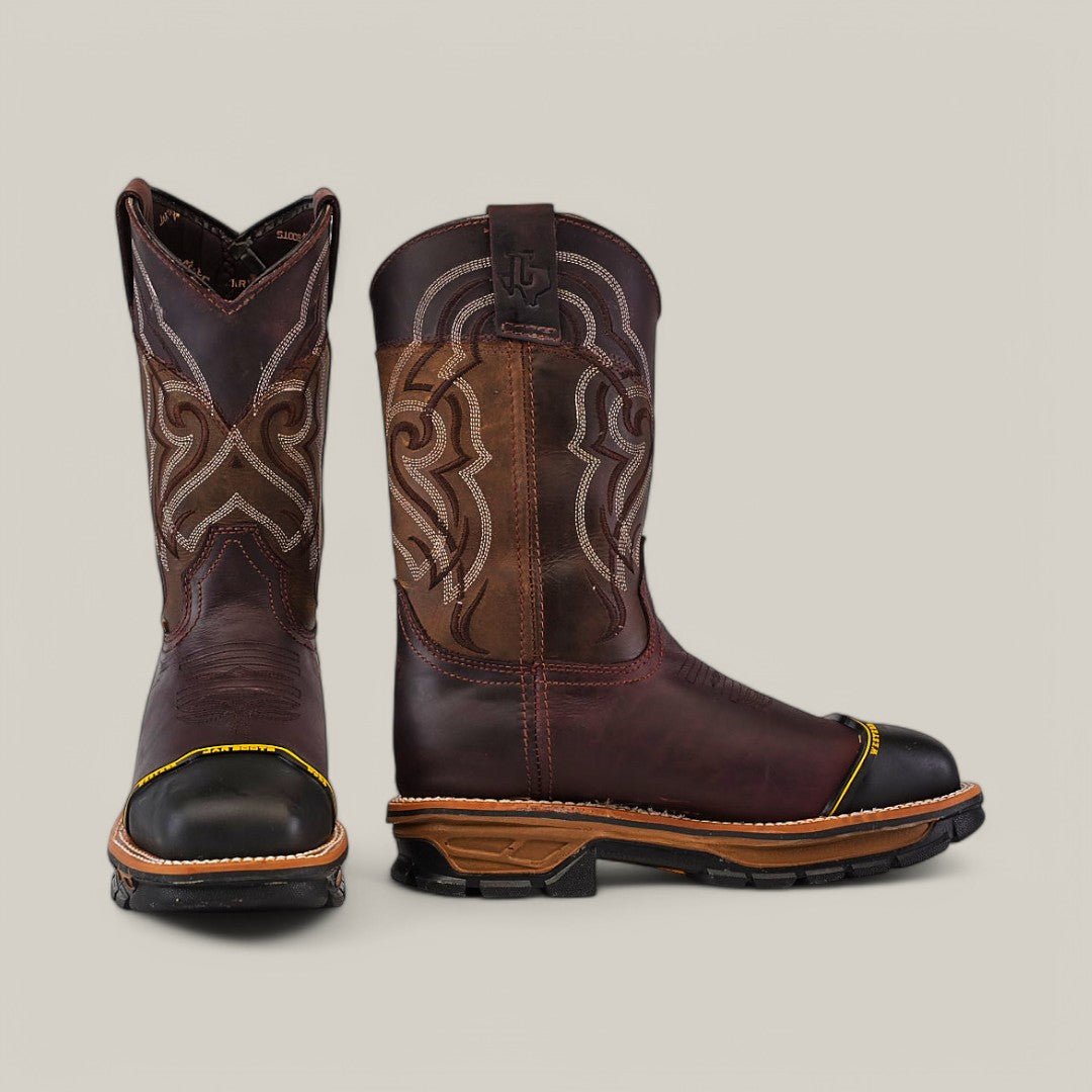 The Amazonas Chocolate Composite Toe - E6258 is a pair of sturdy, durable cowboy boots in brown leather with intricate embroidery. With one boot forward and the other in profile, they feature waterproof black toe caps and textured soles, ideal for Texas Country Work Boots enthusiasts.