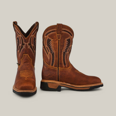 The Floter Honey Soft Toe - E6987 boots feature intricate stitching. One boot is upright, showing its side, and the other displays the front. With black soles against a light grey background, these brown boots blend style with rugged charm.