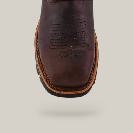 Close-up of the Amazonas Chocolate Soft Toe - E6002 cowboy boot, featuring decorative stitching on the toe and showcasing its durable, comfortable design with a tan welt and black sole, set against a plain light gray background.