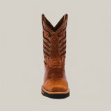 Centered against a plain gray backdrop is a single, intricately stitched brown cowboy boot. This durable Crater Honey Soft Toe - E6087 features a pointed toe and traditional Western design patterns, combining style and strength.