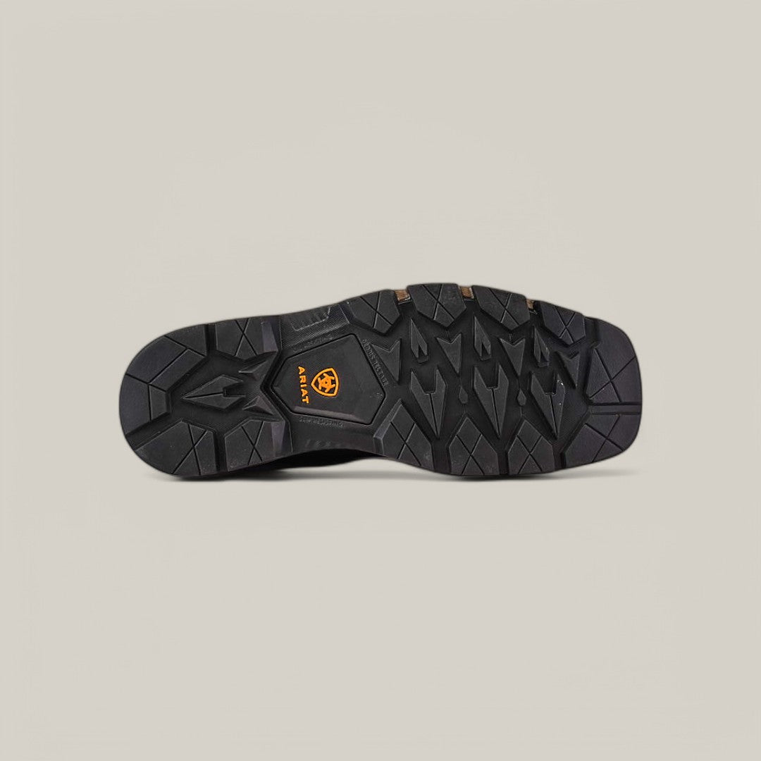 The Rebar Flex Western Brown - Composite Toe (10053616) features a black shoe sole with a rugged tread pattern on a light gray background, showcasing an embossed orange Ariat logo in the center. Inspired by Rebar Flex technology, it includes geometric shapes and grooves for improved traction and durability.