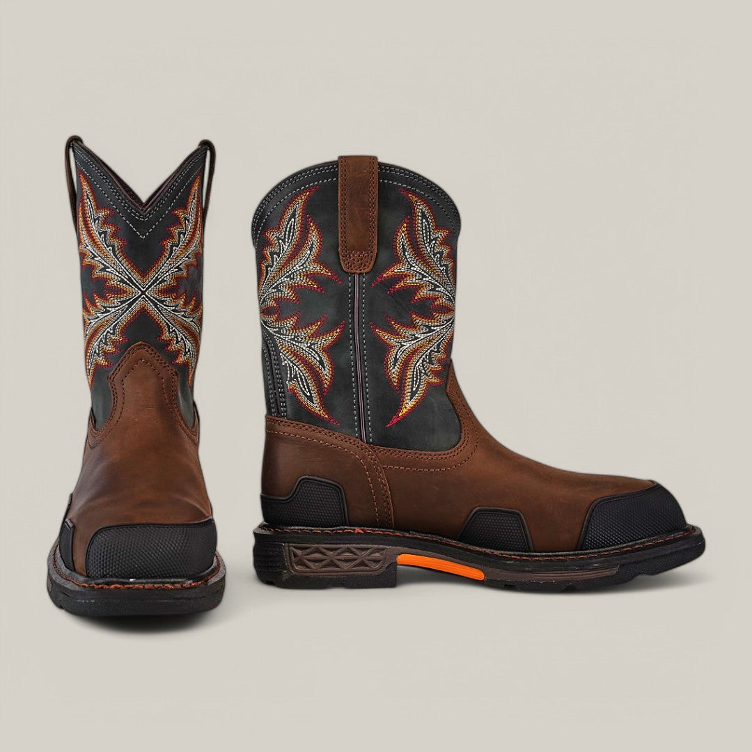 These Overdrive Brown Wide Square Toe boots (10053644) feature a striking design with black accents, orange stitching, and decorative orange and white patterns. The rugged style pairs the squared toe and visible tread against a light gray backdrop for flair and function.