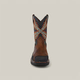 The Overdrive Brown Wide Square Toe boot (Product 10053644) showcases a front view with a decorative shaft featuring geometric shapes in orange, yellow, and blue. It has a rounded toe, black sole, and is set against a plain beige background.