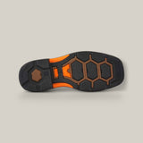 The image showcases the sole of a shoe similar to the Overdrive Brown Wide - Square Toe - 10053644 by Ariat, featuring a black, orange, and brown hexagonal pattern with textured grips on a neutral light gray background—perfect for stylish workwear.