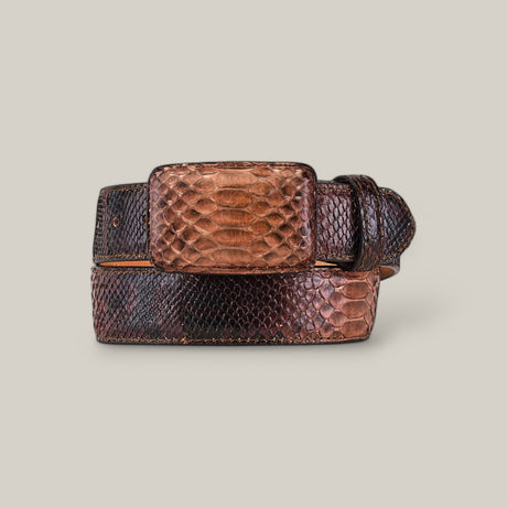 The Exotic Full Quilt Python - Savanna Belt is a luxurious brown leather accessory with a large rectangular buckle, featuring an elegant python pattern in dark brown and tan, set against an off-white background.