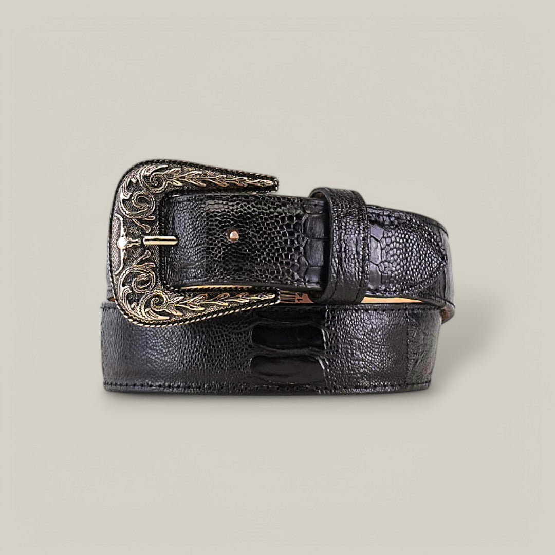 The Exotic Full Quilt Ostrich Leg - Texas Buckle - Black Belt is a textured black leather belt featuring a gold-toned buckle with intricate scrollwork, coiled to showcase its elegant design and craftsmanship.