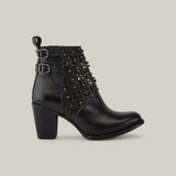 The Black Laser & Crystals - Round Toe - CU439 boot showcases floral cut-out designs, sparkling crystals, silver studs, and two small buckles. It features a chunky heel and polished texture against a plain gray backdrop.