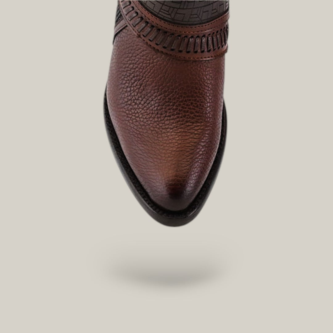 Close-up of the tip of a brown leather Honey Laser & Woven - Round Toe - CU619, showcasing intricate stitching detail, reminiscent of woven round toe boots, against a light gray background.