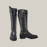 A pair of tall, sleek Black Stingray Zipper boots (Round Toe - FC637), one upright and the other lying down, showcase an inner-side zipper and elegant stingray leather with a subtle textured design on the front.