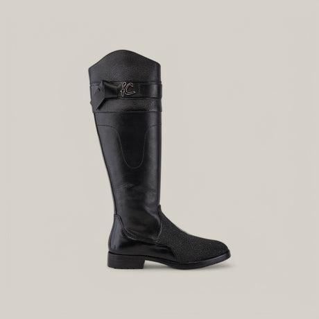 The Black Stingray Zipper - Round Toe - FC637 boot features a single black knee-high design crafted from stingray leather, with a flat heel, decorative stitching, textured surface, and a top strap with metallic logo accent. The background is plain light gray.