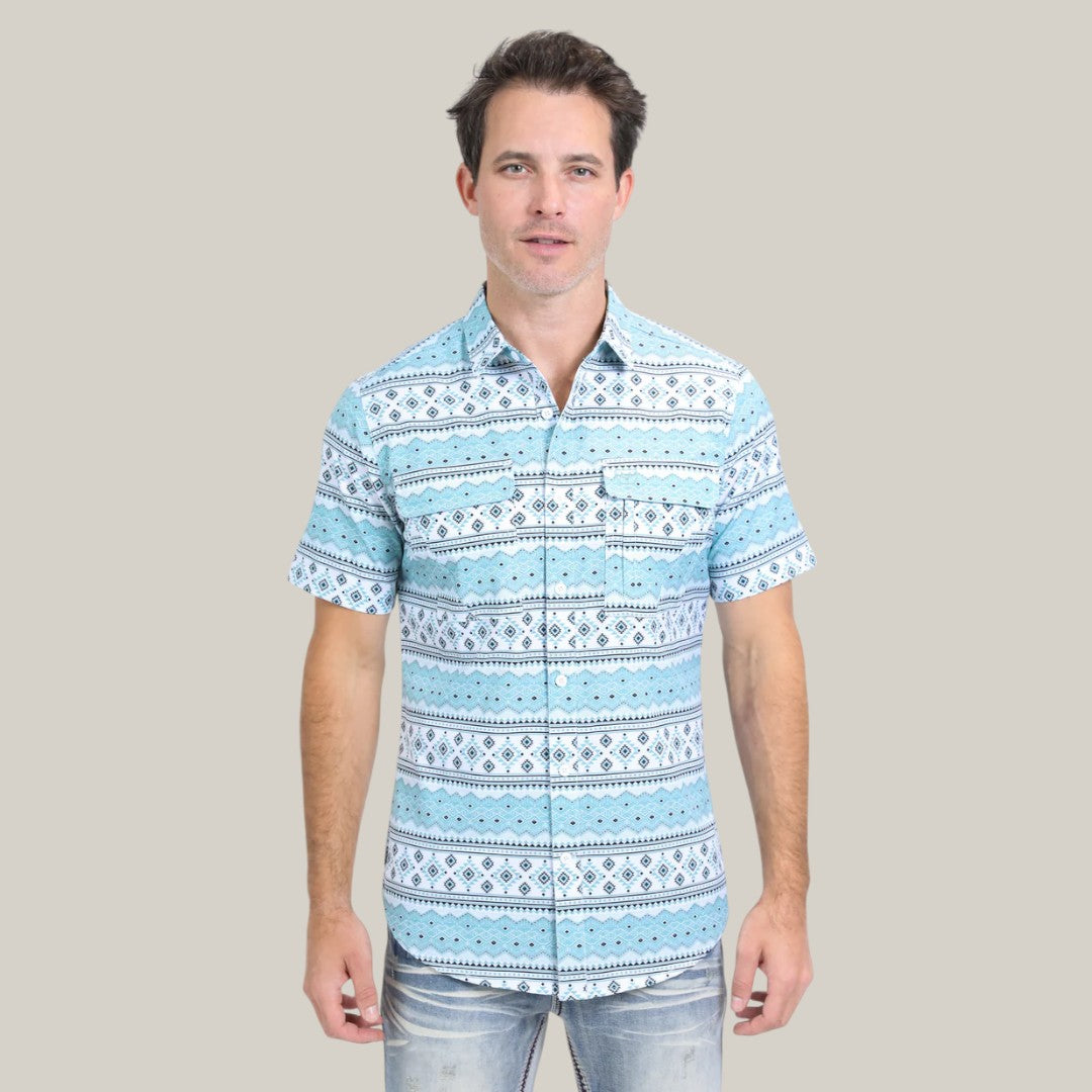 A person stands against a plain background wearing the Mens Performance Western Short Sleeve Aztec Print White Shirt (PGS10627), featuring horizontal blue and white geometric patterns.