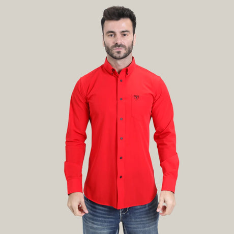 A man in a Men’s Single Pocket Logo Modern Fit Stretch Dress Shirt - Red - CTL10700 stands against a light grey background, wearing blue jeans. The shirts stretch fabric enhances his comfort as his hands rest at his sides.