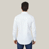 A person with dark hair, facing away from the camera, wears the Mens Western Modern Fit White Long Sleeve Shirt with Snaps (WPL10387). The shirts blue geometric pattern complements dark jeans against a simple light gray backdrop that highlights its sleek style.