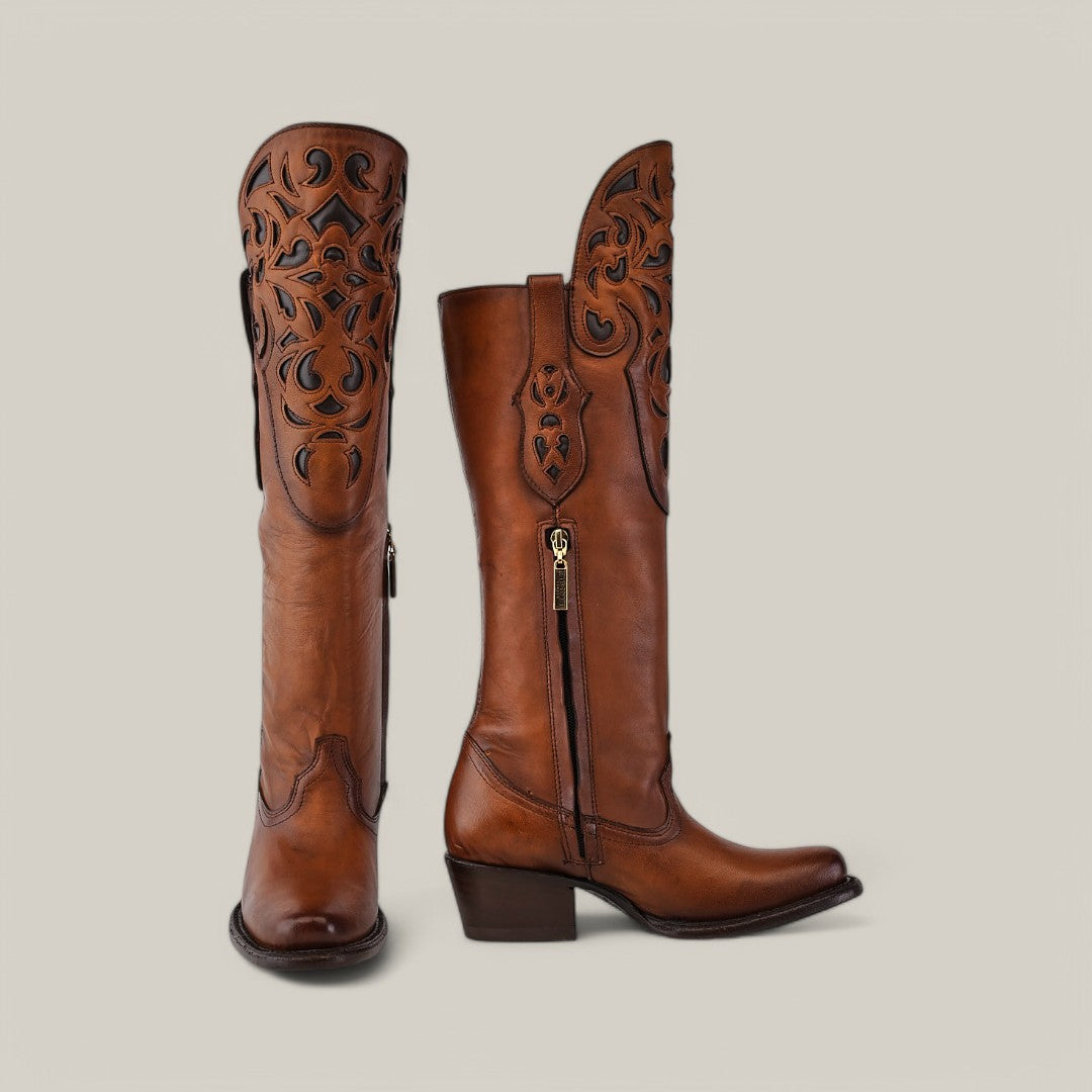 The California Tall Shaft Honey - Round Toe from the Platinum Collection showcases intricate cut-out patterns on brown cowboy boots with a mid-height heel, standing side by side against a plain background. They feature a visible zipper on the side, ideal for Round Toe boot enthusiasts.