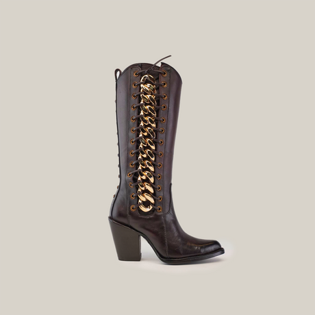 Introducing the Francia Rings Tall Shaft Chocolate, a luxury boot made from premium chocolate leather with a knee-high design. It features a chunky heel, elegant lace-up style, striking gold chain detailing on the side, and a convenient pull tab at the top.