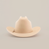 The 6X 2 Carnales Bone, a classic western beige felt cowboy hat with a wide, curved brim and crown crease, is featured against a plain white background.