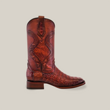 An Exotic Caiman Belly Tail cowboy boot in brandy, featuring a textured caiman pattern, square toe, Goodyear welt sole, and high shaft with decorative stitching. The Western footwear is set against a plain white background.