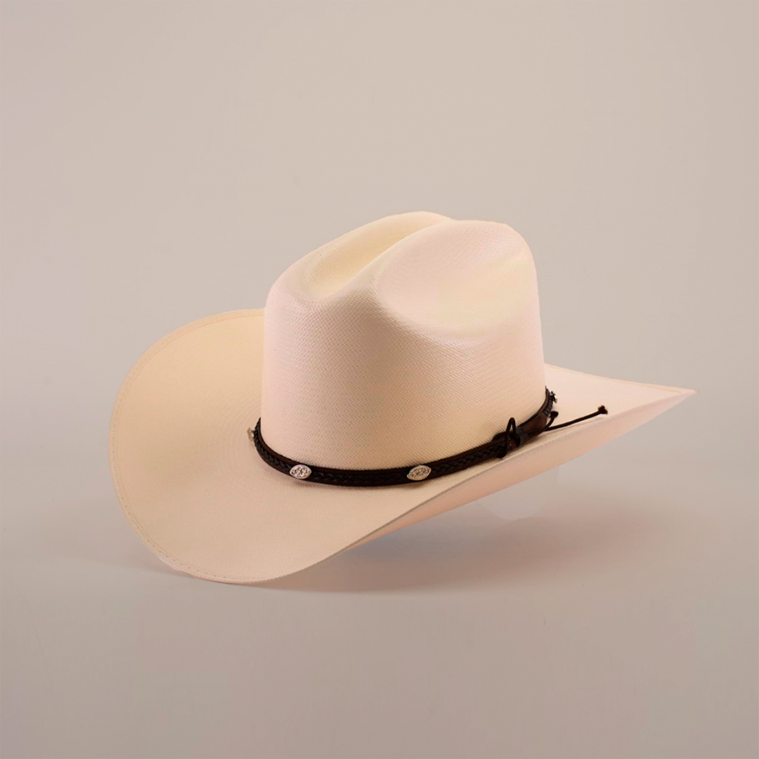 The 1000X Sinaloa Straw Hat is a cream-colored cowboy hat with a wide brim, featuring exceptional quality and a black braided band adorned with small silver embellishments, set against a plain white background to highlight its elegant design.