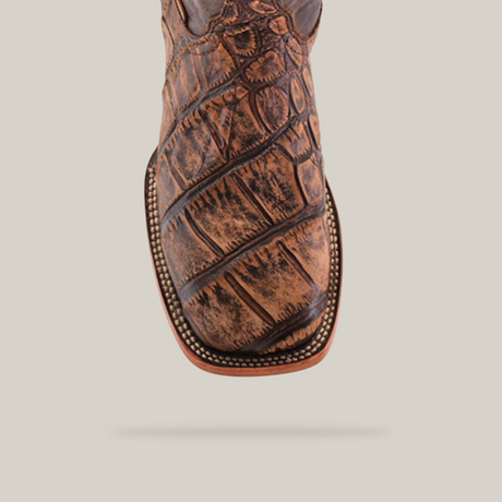 A close-up of the American Alligator Print Rustic Brown - Square Toe boot showcases its textured brown leather and detailed stitching, all elegantly highlighted against a plain white background.