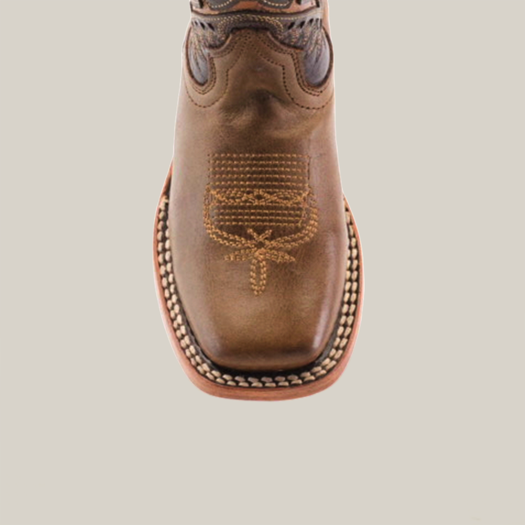 The Ranch Camel Square Toe cowboy boot in brown highlights western elegance with intricate toe stitching. Made from premium cowhide leather, it features a rounded front, decorative stitching along the sole, and is set against a plain white background.