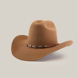 The 6X Leandro Fawn is a premium sheeps wool cowboy hat featuring a wide brim and a decorative leather band with metallic accents, set against a plain white background.