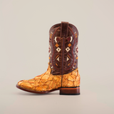 The Exotic Pirarucu Fish Patchwork Honey Square Toe cowboy boot highlights intricate geometric patterns on a dark brown shaft, complemented by a textured, multicolored beige and orange foot. With its wooden sole and pull tab on top, it features patchwork design for added charm.