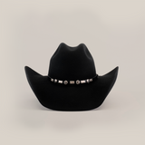 The 6X Chihuahua Black cowboy hat features a decorative band with silver conchos and designs, all on a plain white background.