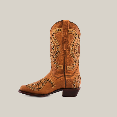 The Love Crystals Honey boot features premium leather in brown with intricate patterns and cutouts on the shaft. Its handmade design includes a convenient pull strap, a low heel, and is displayed against a white background.