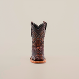 The Alligator Head Print Rustic Honey Square Toe boot, meticulously handcrafted from premium leather, features intricate stitching against a plain white background. With its distinctive square toe and low heel, it embodies timeless western fashion.