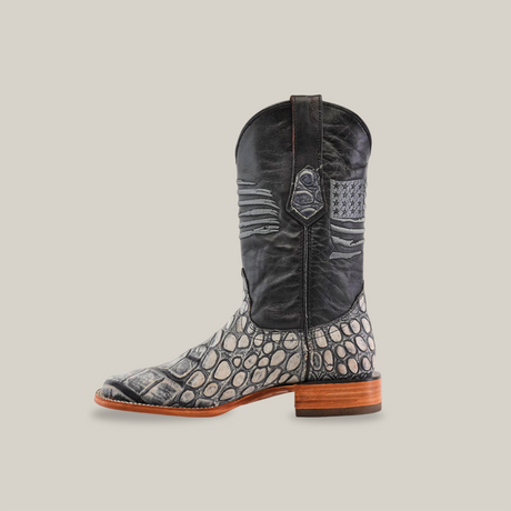 The American Alligator Print Rustic Black - Square Toe cowboy boot features a textured gray and black upper, an alligator print, square toe, wooden sole, and leather pull strap, highlighted against a white background.