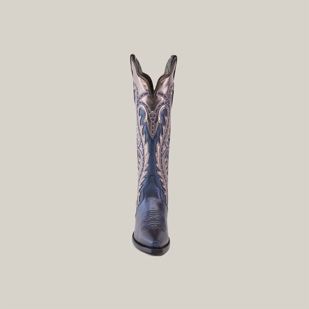 A single Valentina Navy boot stands centered against a plain white background, showcasing its dark blue leather with intricate lighter stitching, snip toe, and ornate design that reflects its artisanal craftsmanship.